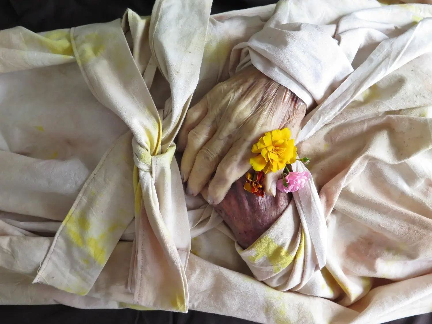 shroud with flowers and hands